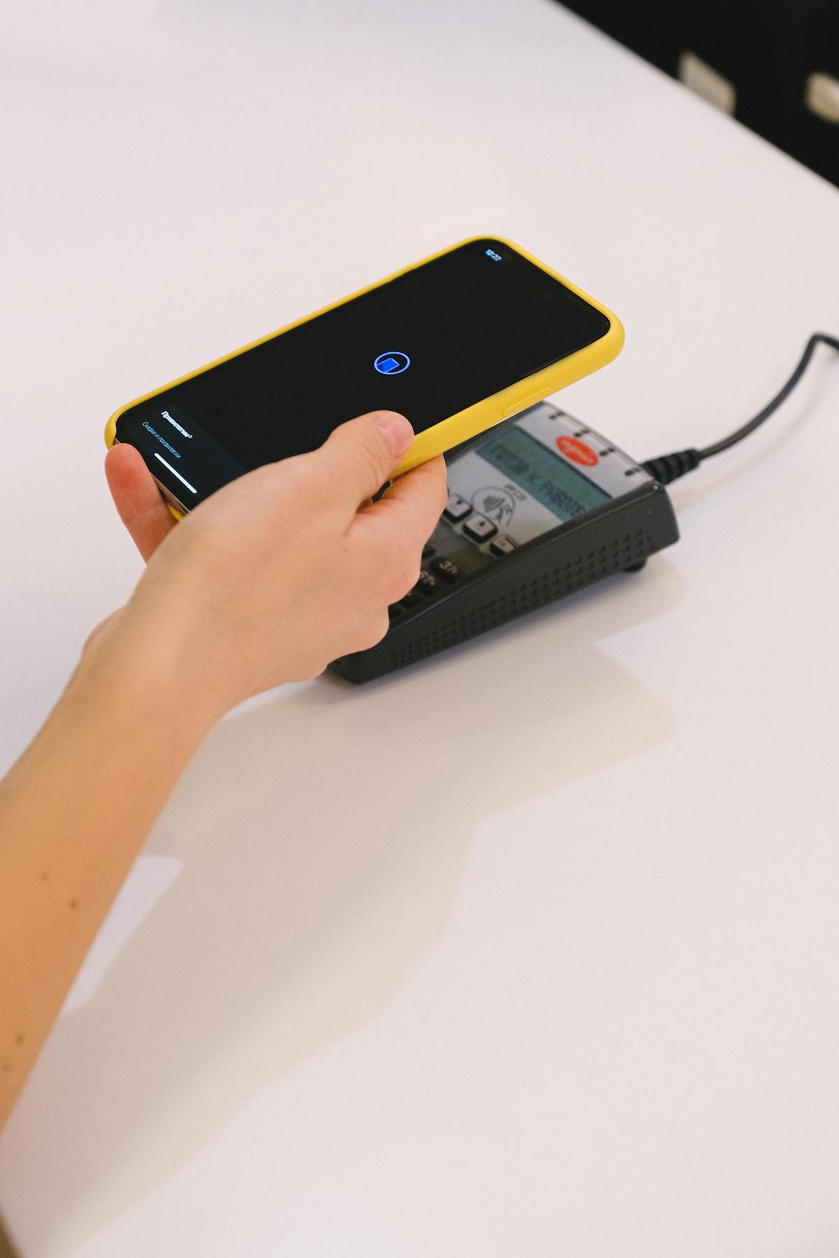 スマホをかざしたタッチ決済、デビットカード利用や入金手続きを連想させる